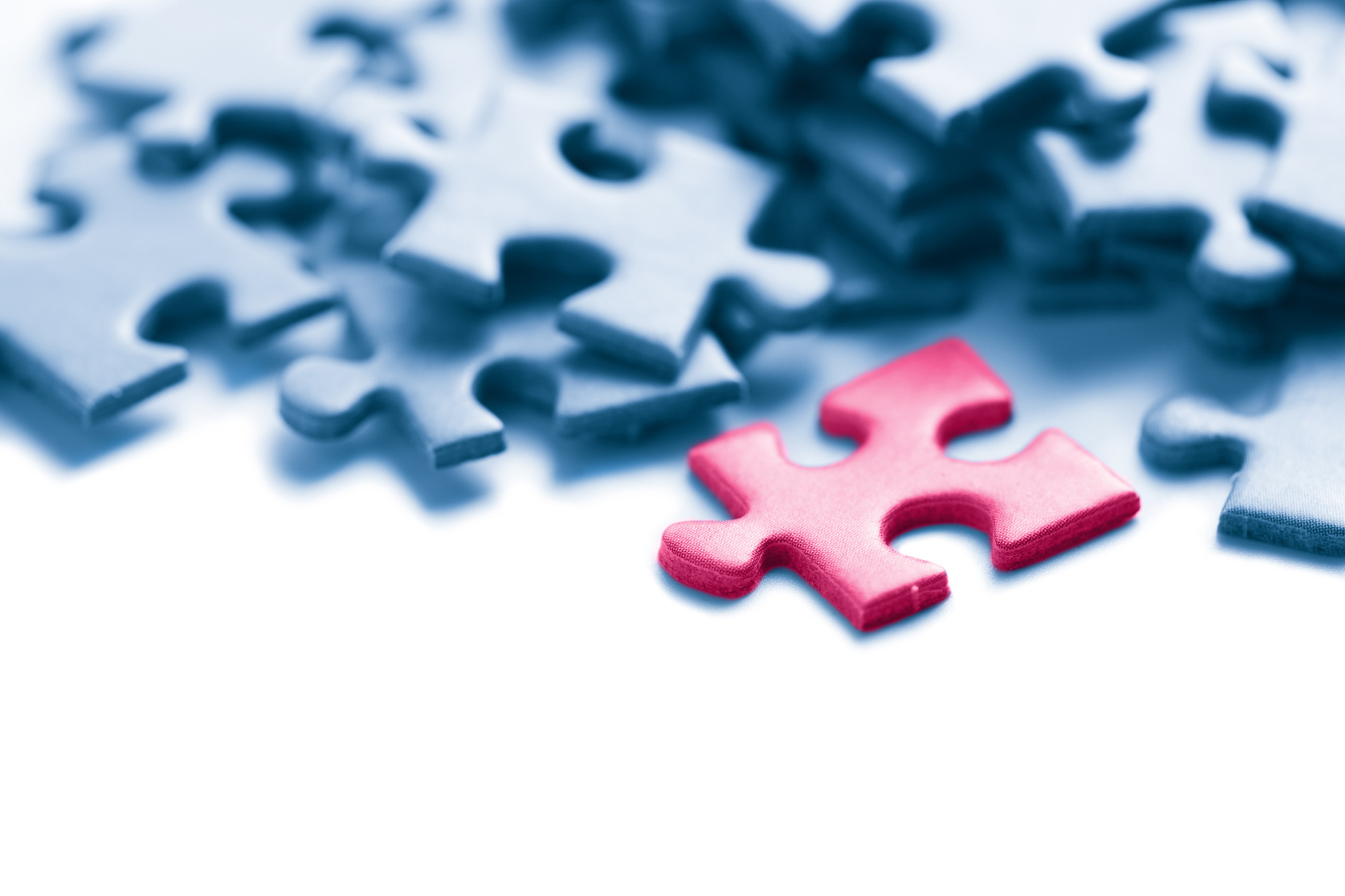 blue puzzle with one pink piece